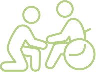 An icon of a person assisting another person in a wheelchair, depicted with green outlines.